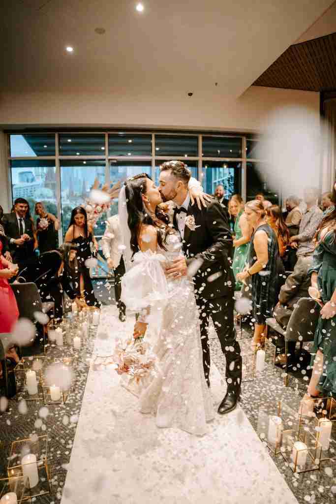 bride and groom kissing at metropolis events luxury wedding venue in southbank