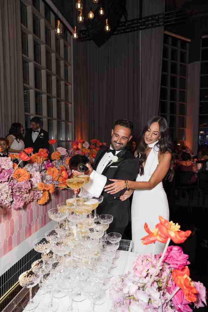 a bride and groom pouring champagne at their wedding in Metropolis luxury wedding venue Melbourne